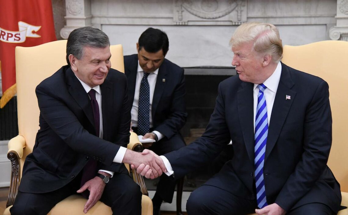 A photograph of the leaders of the United States and Uzbekistan shaking hands in the Oval Office at the White House in 2018.