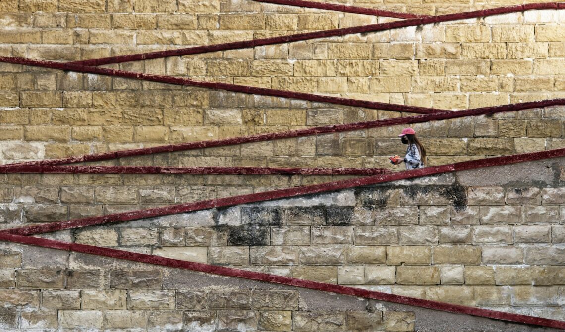 Woman in front of Cospicua fortress in Malta.