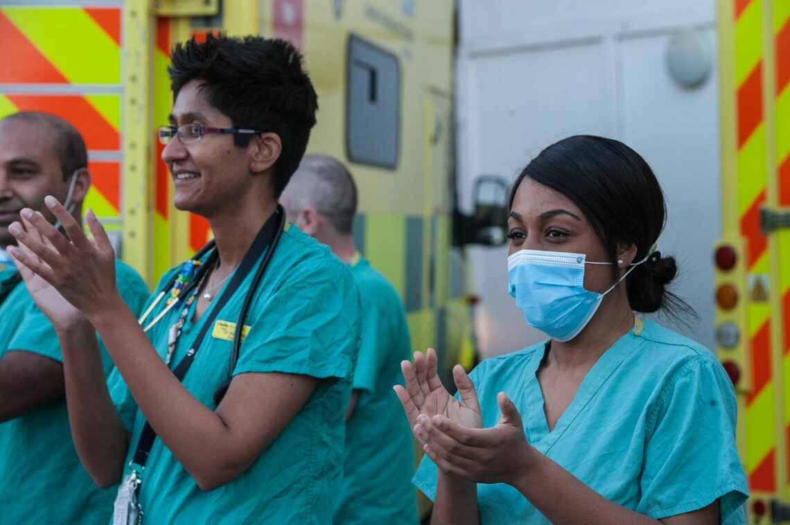 British healthcare workers applaud their colleagues post-pandemic UK
