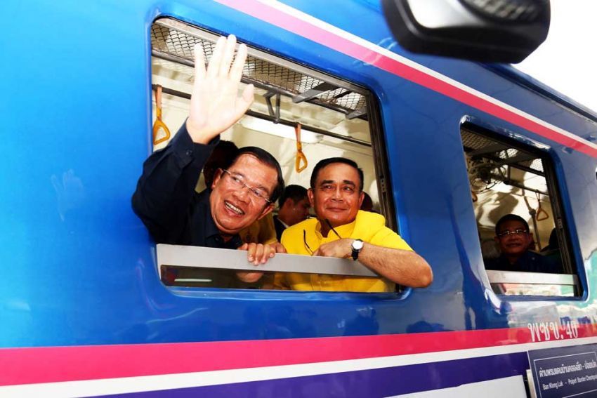 Cambodian Prime Minister Hun Sen and Thai Prime Minister Prayuth Chan-Ocha look out a train window Cambodia China relationship