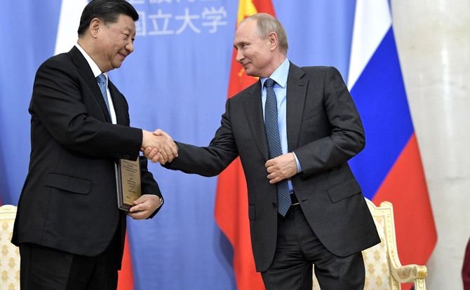 A photo of Chinese President Xi Jinping shaking hands with Russian President Vladimir Putin at a June 2019 meeting in St. Petersburg.