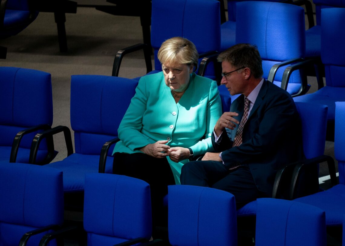 German Chancellor Angela Merkel talks to fellow CDU politician Matern von Marschall