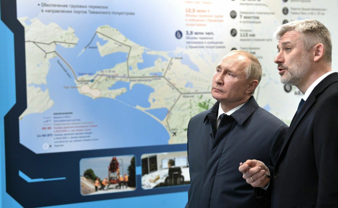 President Vladimir Putin and Minister of Transport Yevgeny Dietrich look at information stands