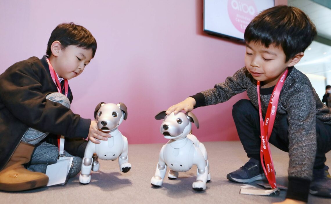 Children play with Aibo robotic dogs at Sony’s headquarters in Tokyo Japan leaps bounds