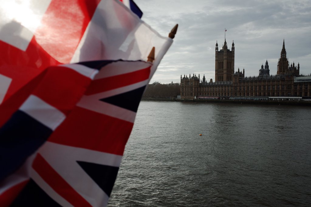 Union Jack flags flutter in the breeze at a souvenir stall across the River Thames from the Houses of Parliament in London, England, on January 7, 2020