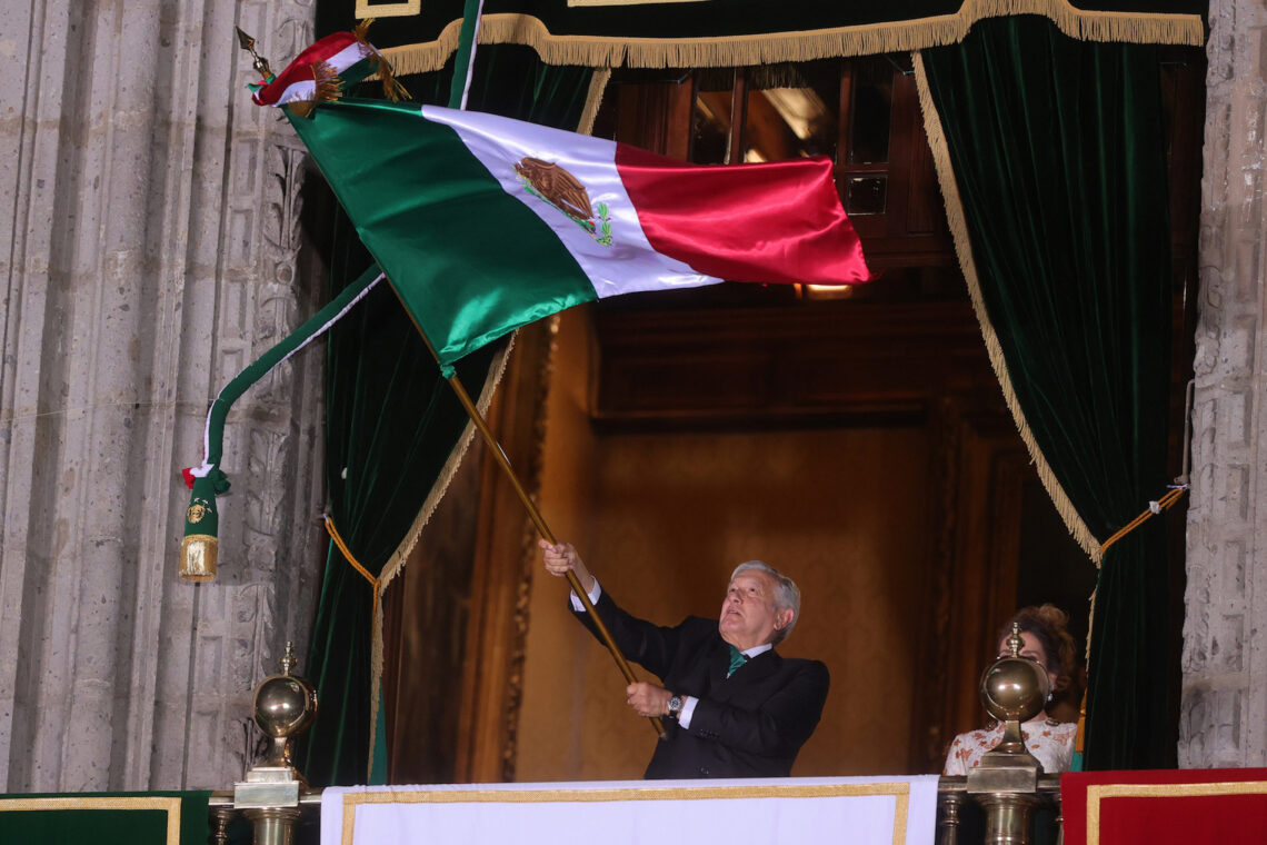 Mexican President Andres Manuel Lopez Obrador waves a Mexican flag as he gives the annual independence during Independence Day celebrations on September 15, 2020 in Mexico City, Mexico