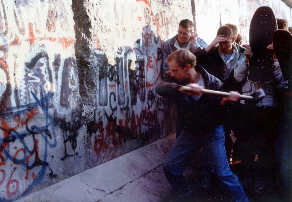 A German takes a hammer to the Berlin Wall on November 9, 1989