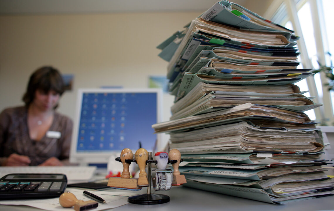 Piles of paper and folders in a government office