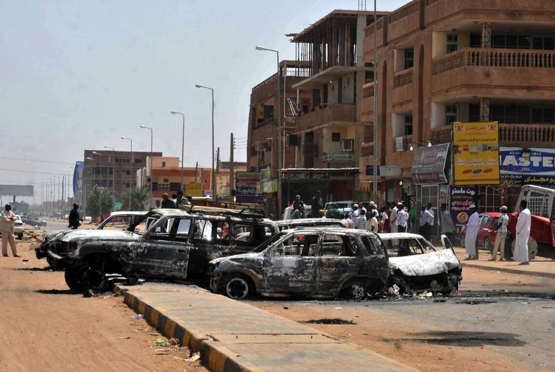 Torched cars on the streets of Khartoum after Sudanese protests against fuel subsidy cuts