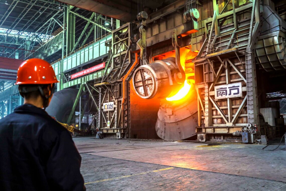 A Chinese worker surveys the production of steel at a plant in the eastern Chinese province of Shandong, 23 February 2018