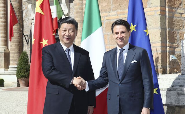 Leaders of China and Italy shake hands before their talks in Rome