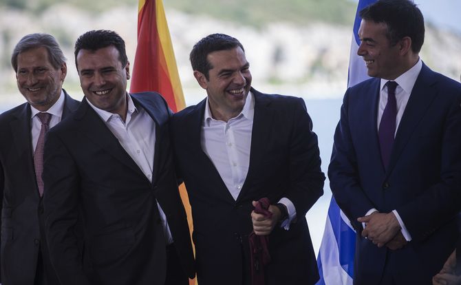 The prime ministers of Greece and Macedonia embrace after settling their name dispute