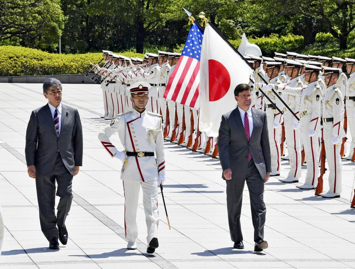 U.S. Defense Secretary Mark Esper walks with (now former) Defense Minister Takeshi Iwaya in front of an honor guard in Tokyo in August 2019