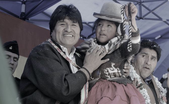 Evo Morales holds a child at a political rally