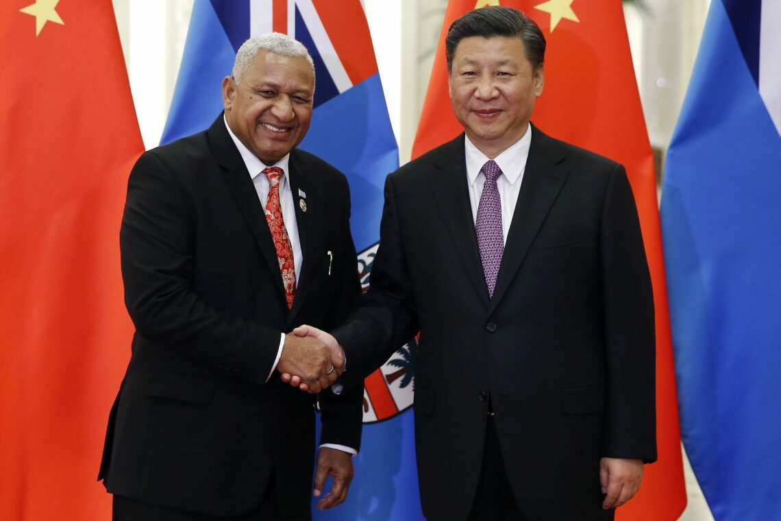 Fijian Prime Minister Frank Bainimarama shakes hands with Chinese President Xi Jinping