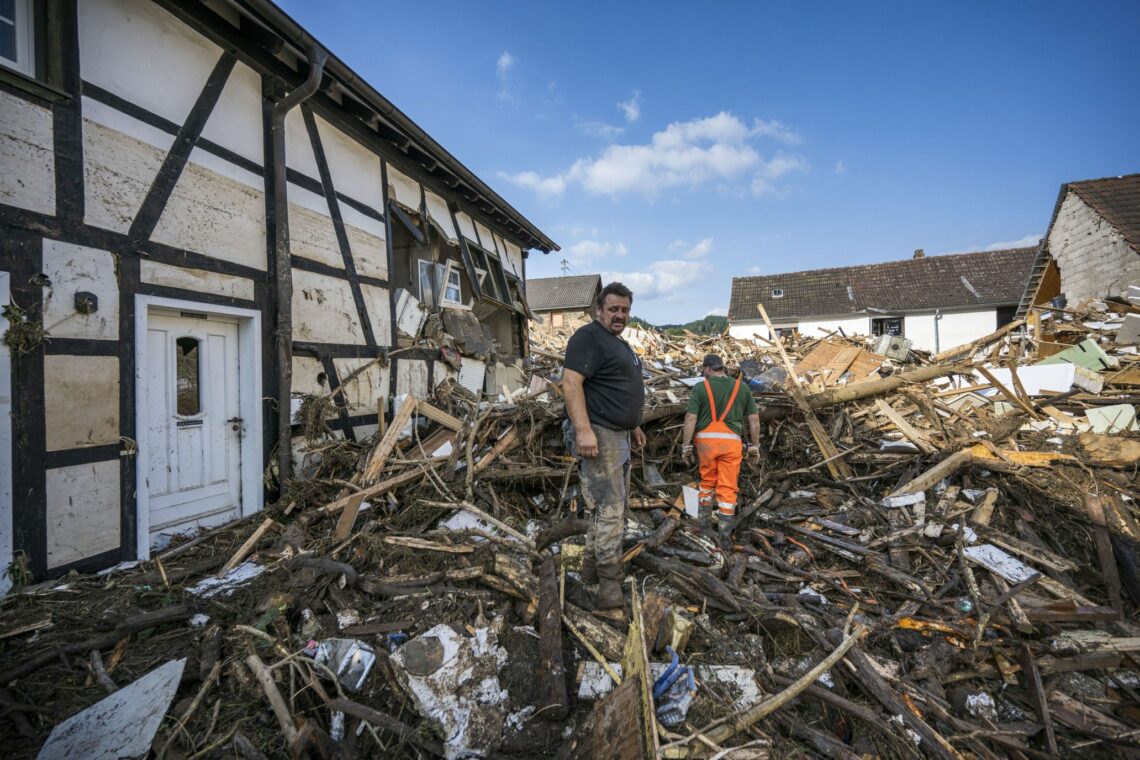 A German man surveys the damage after the flood