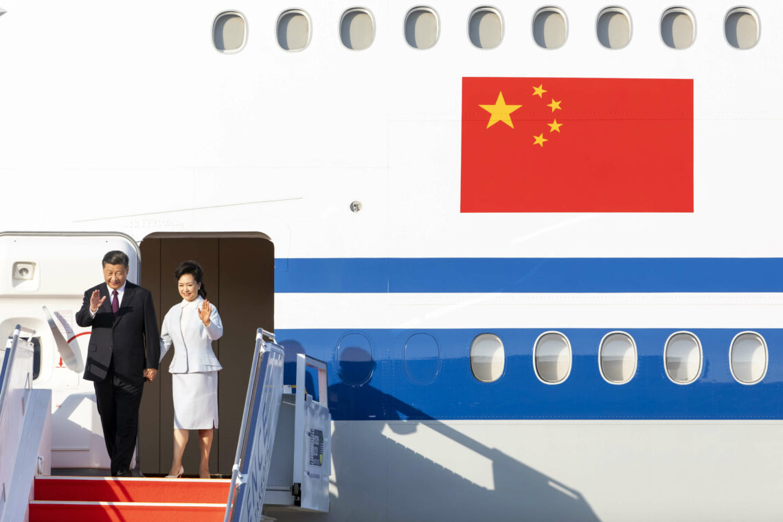 President Xi Jinping and a Chinese flag