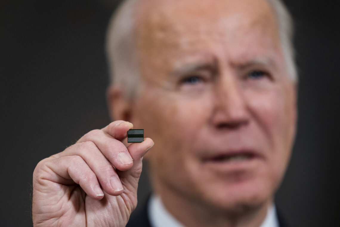Joe Biden holding a semiconductor