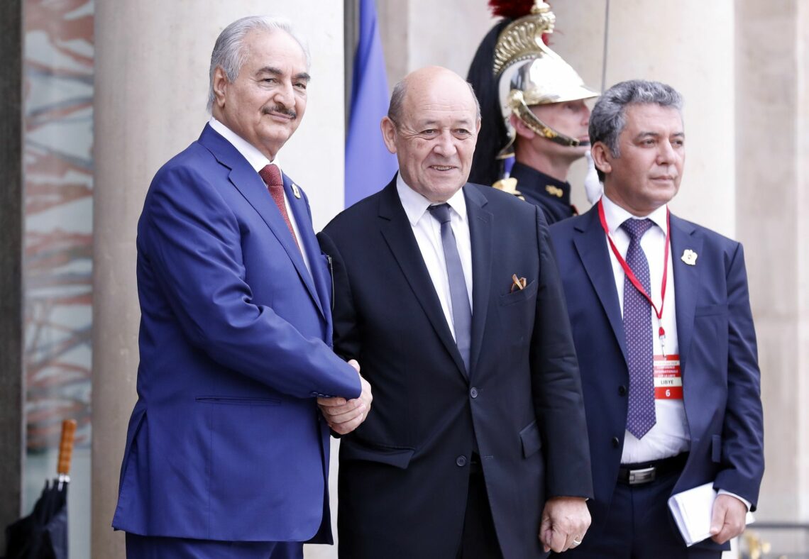 French Foreign Minister Jean-Yves Le Drian greets Libyan strongman Khalifa Haftar