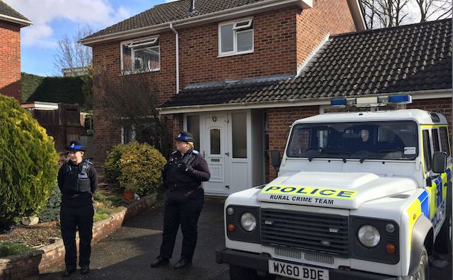 A picture showing British police guarding a home in Salisbury Theresa May accused Kremlin