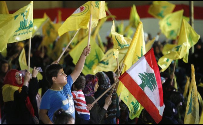 Hezbollah supporters hold flags during an August 2018 speech by Hassan Nasrallah, the group’s leader.