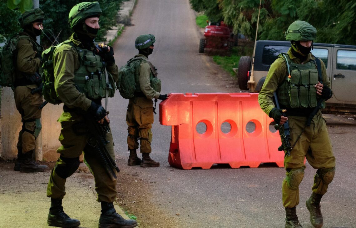Israeli soldiers stand guard at a checkpoint near the border with Lebanon.