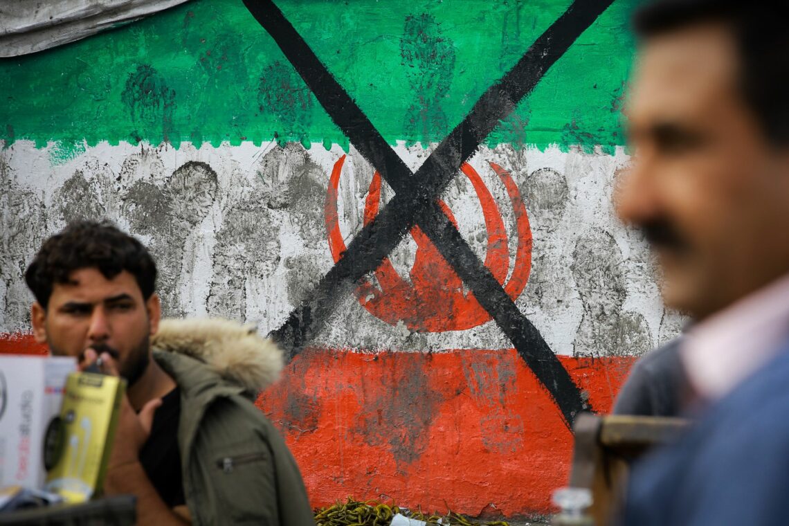 A defaced image of the Iranian flag during a demonstration in Baghdad, Iraq