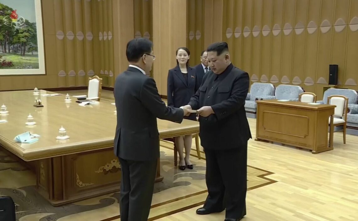 North Korean leader Kim Jong-un receives a letter from South Korean officials with two hands Pyongyang's nuclear program
