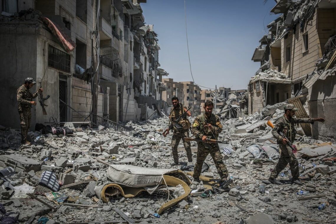 Syrian Kurdish troops patrol the streets of Raqqa after taking the city from Islamic State