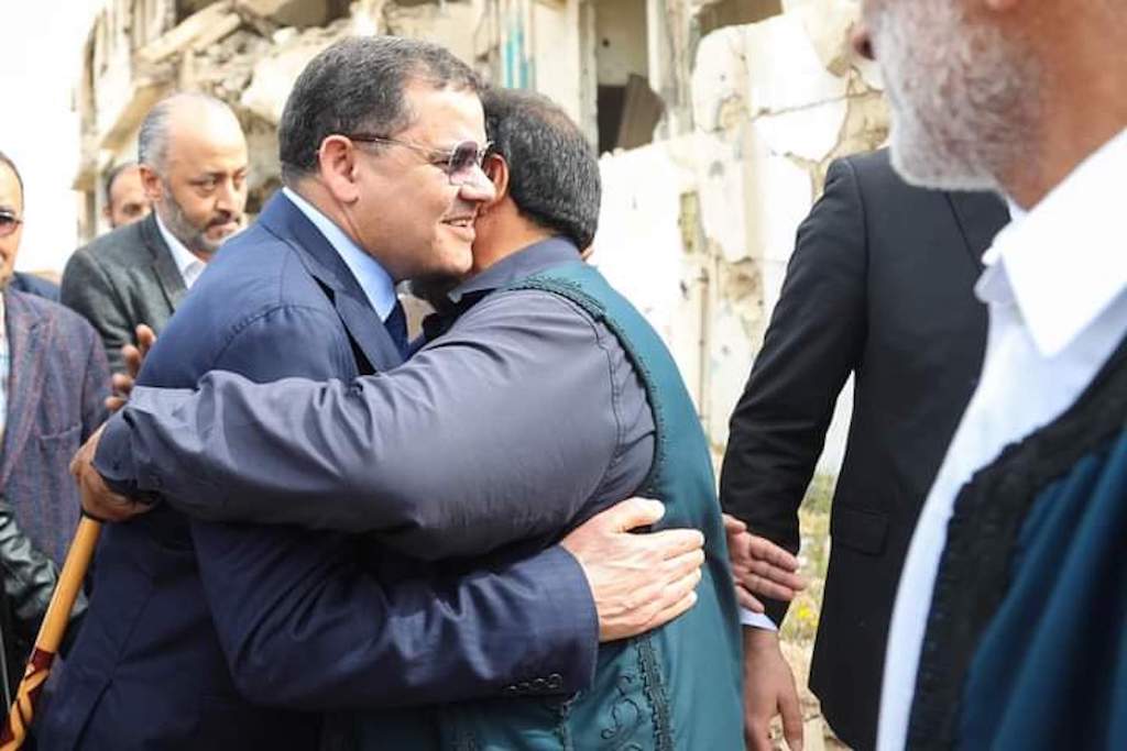 Libya’s new Prime Minister Abdul Hamid Dbeibeh (L) exchanges hugs with a citizen after the HoR voting in the city of Sirte Libyan unity government