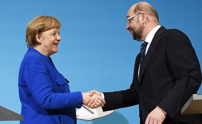 German Chancellor Angela Merkel and SPD leader Martin Schulz shake hands