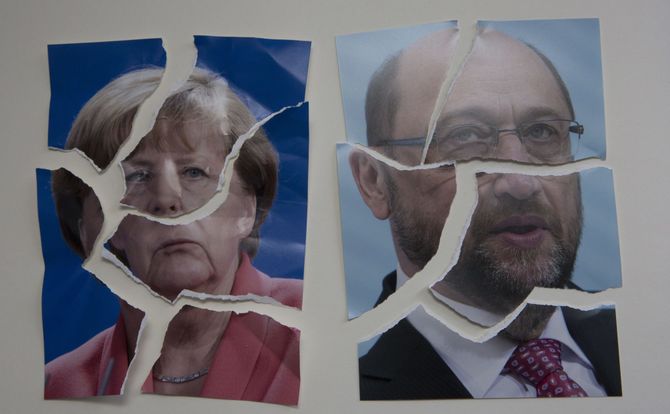 Torn photos of German Chancellor Angela Merkel and SPD leader Martin Schulz coalition agreement CDU-CSU
