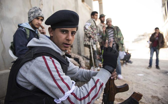 Libyan militia fighters taking a break from street combat