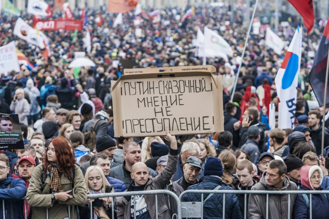 A protester holds up a sign at a protest rally in Moscow