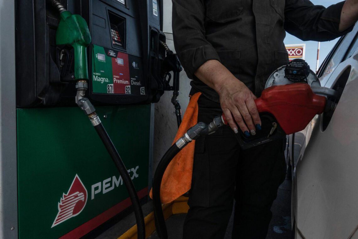 A worker pumps fuel into a car at a Pemex gas station in Tepic, Mexico, on April 22, 2020