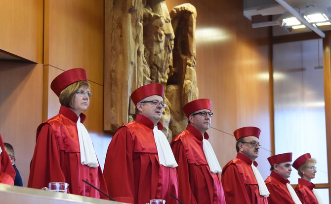A picture showing six justices of Germany’s highest court resplendent in their red robes and headgear at the opening of a hearing on the ECB’s policies