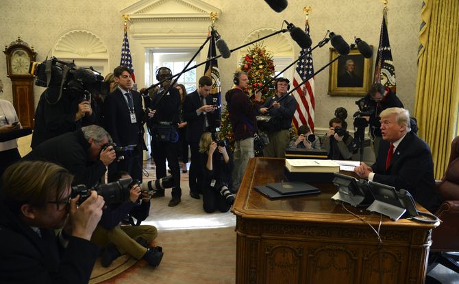 U.S. President Trump speaks with reporters after signing the tax reform bill