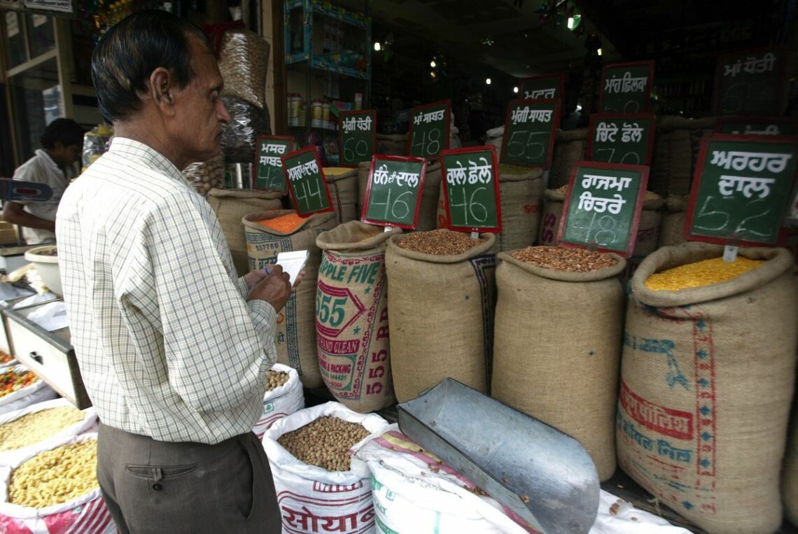 Buyer checks grain and pulse prices in the northern Indian city of Amritsar during a period of high inflation in 2011