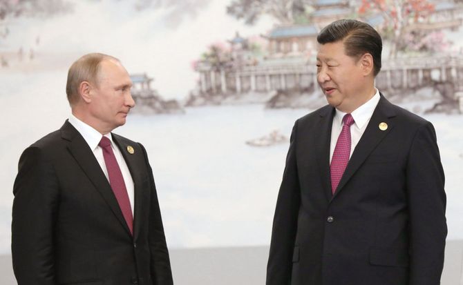Russian President Vladimir Putin and Chinese President Xi Jinping attend a photo session during a BRICS summit in 2017.