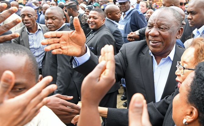 South Africa’s president greets voters at a polling station in Johannesburg