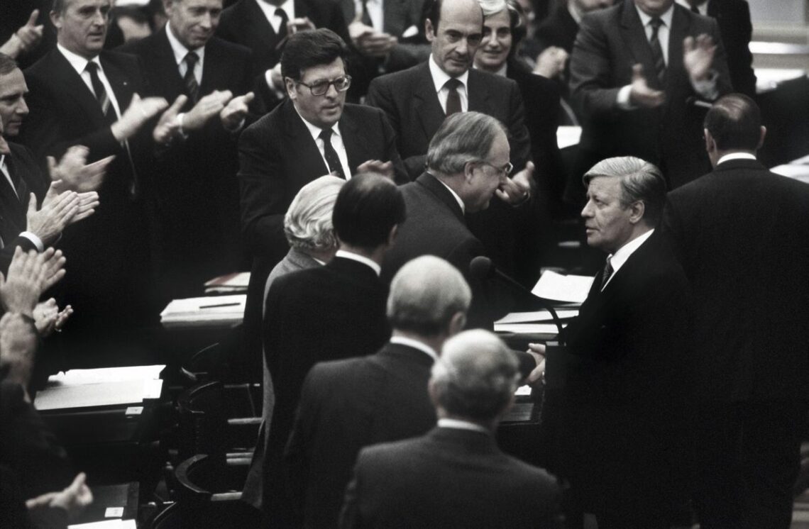 German Chancellor Helmut Schmidt congratulates his successor Helmut Kohl after losing a no-confidence vote in 1982
