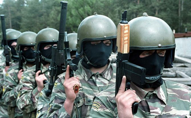 Russian special forces troops in masks holding firearms