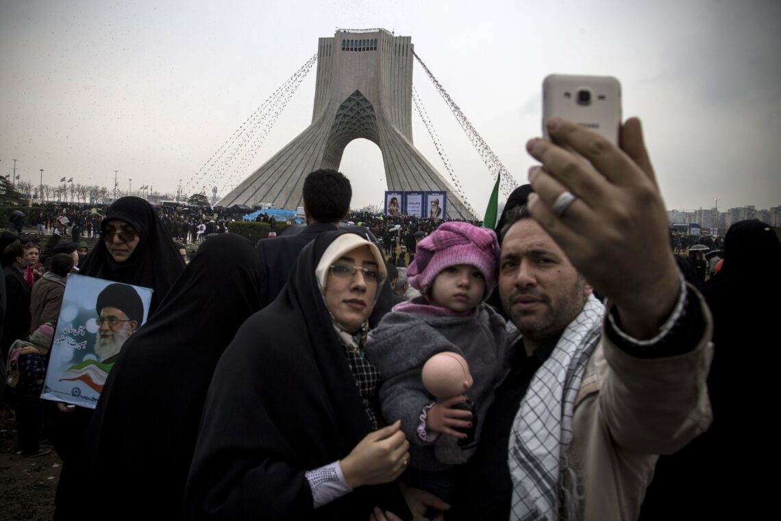An Iranian family poses for a selfie during 40th-anniversary celebrations in Tehran of the Islamic Revolution