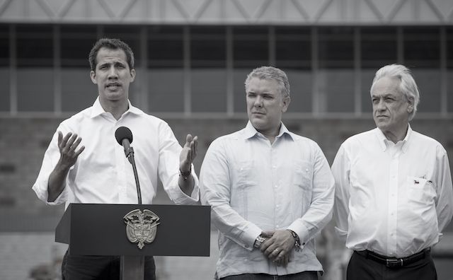 Presidents of Colombia and Chile standing shoulder-to-shoulder with Venezuela’s opposition leader on the stage of an open-air concert at a border town in Colombia where humanitarian aid to starving Venezuelans is stored