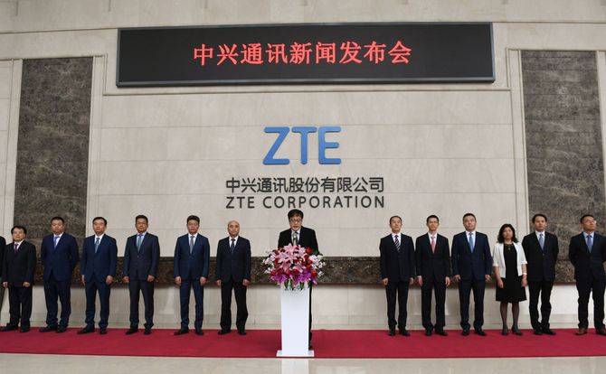 ZTE CEO Yin Yimin, flanked by company executives, speaks to the press on April 20, 2018, addressing U.S. sanctions