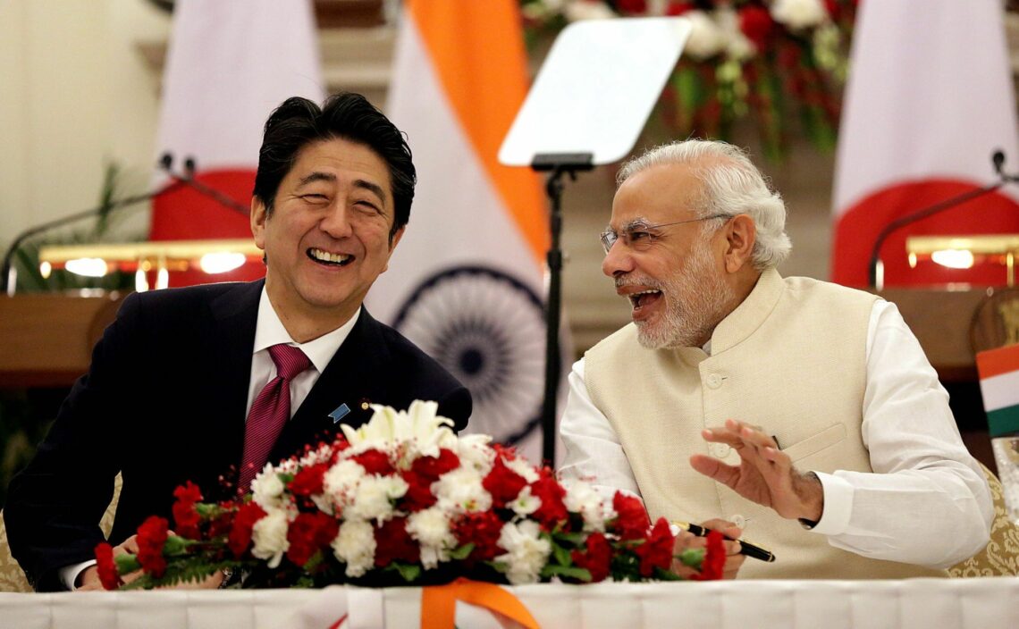 Japanese Prime Minister Shinzo Abe (L) and Indian Prime Minister Narendra Modi share a laugh during a 2015 summit