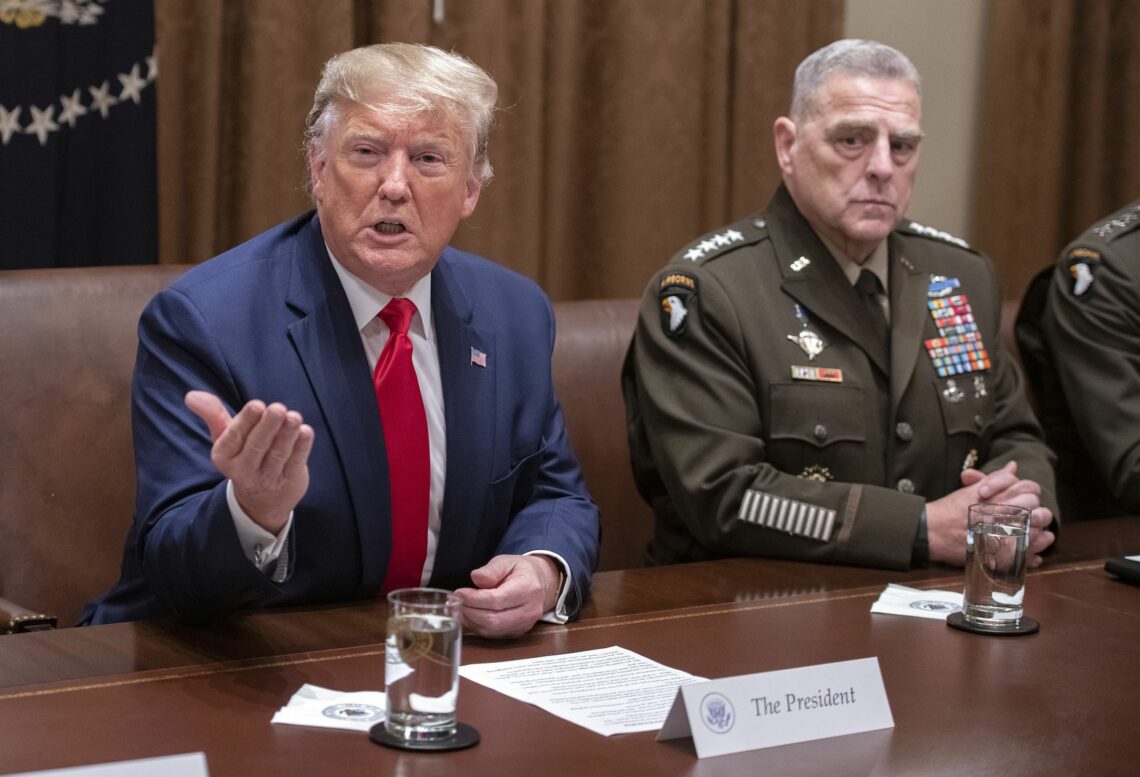 General Mark A. Milley listens as US President Donald Trump speaks U.S. civilian-military