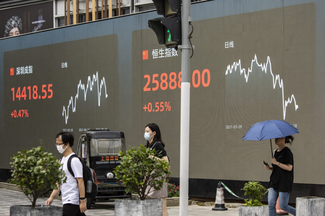 A screen displaying the Shenzhen Stock Exchange and the Hang Seng Index figures in Shanghai, China