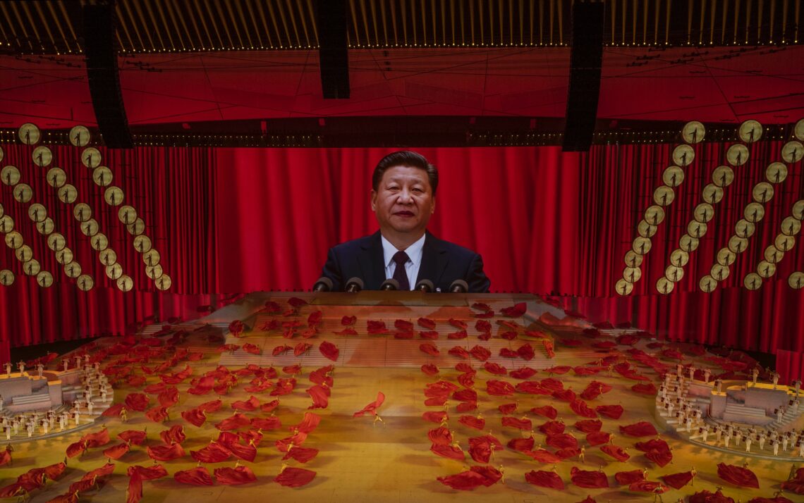 Chinese President Xi Jinping appears on a large screen as performers dance during a gala marking the 100th anniversary of the Communist Party in Beijing.
