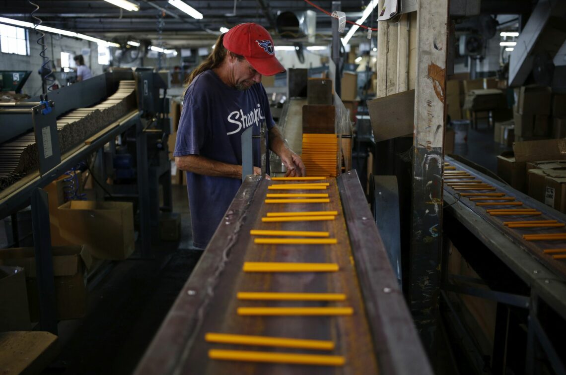 A man works at a pencil production line in Shelbyville, Tennessee
